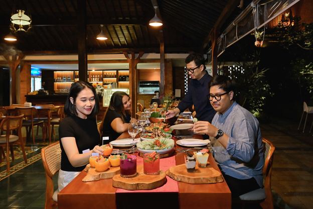 Tamu bersantap di meja kayu VANA SHANKARA
